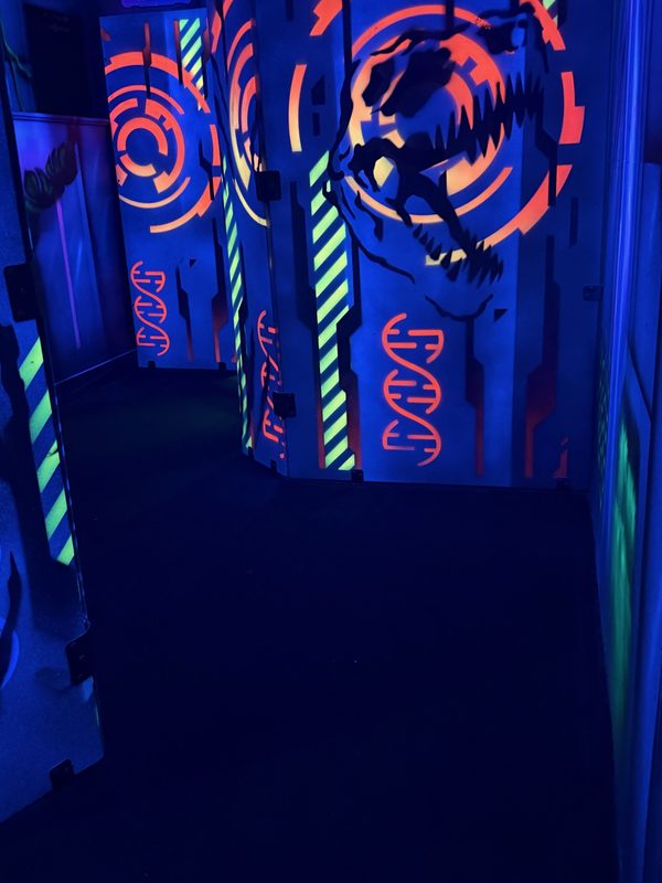 A bunker painted with a glowing orange dinosaur skull and DNA strands