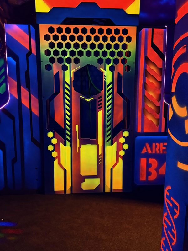 The Area 134 bunker with a hex window, orange hazard stripes and glowing yellow panels